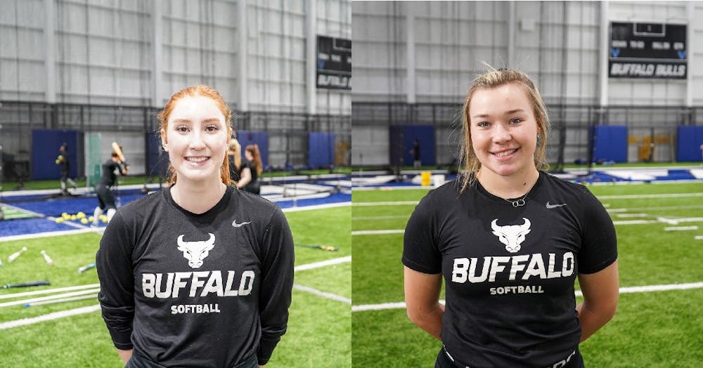 <p>Freshmen pitchers Alexis Lucyshyn and Madelyn Hickingbottom discuss their experiences being on the UB women's softball team during practice at the UB fieldhouse on Tuesday.</p>