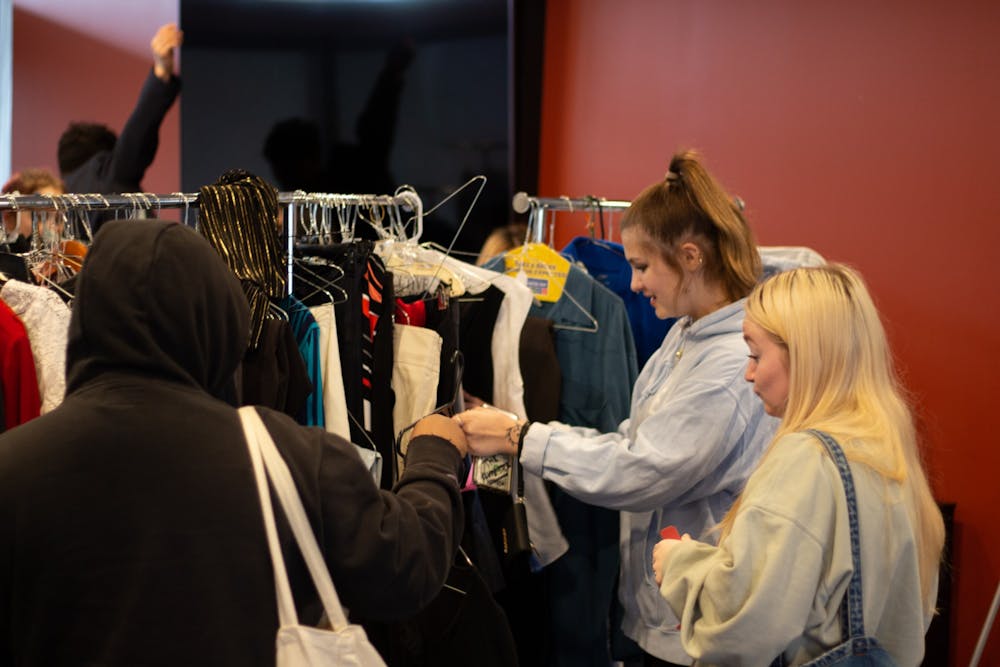 <p>Students look through clothes at a recent UB Hired event.&nbsp;</p>