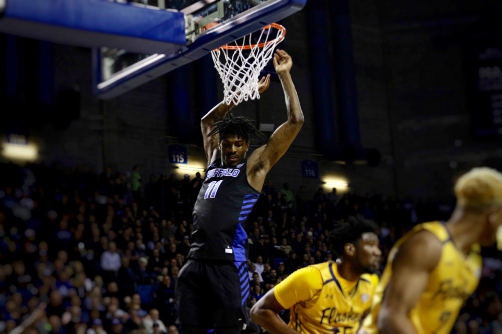<p>Freshman forward Jeenathan Williams finishes off a dunk for his only points of the game. The Bulls won in front of a sellout crowd of 6,688.</p>