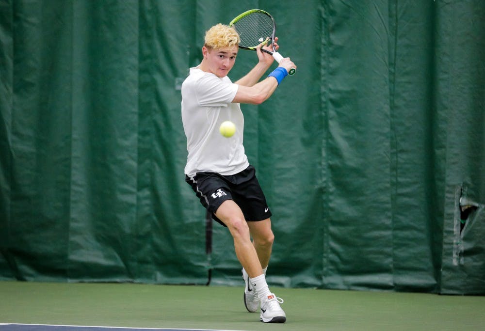 <p>Freshman Nickolas Frisk prepares to hit the ball with a back hand. The Bulls picked up two wins this weekend to improve its conference record to 3-1.</p>