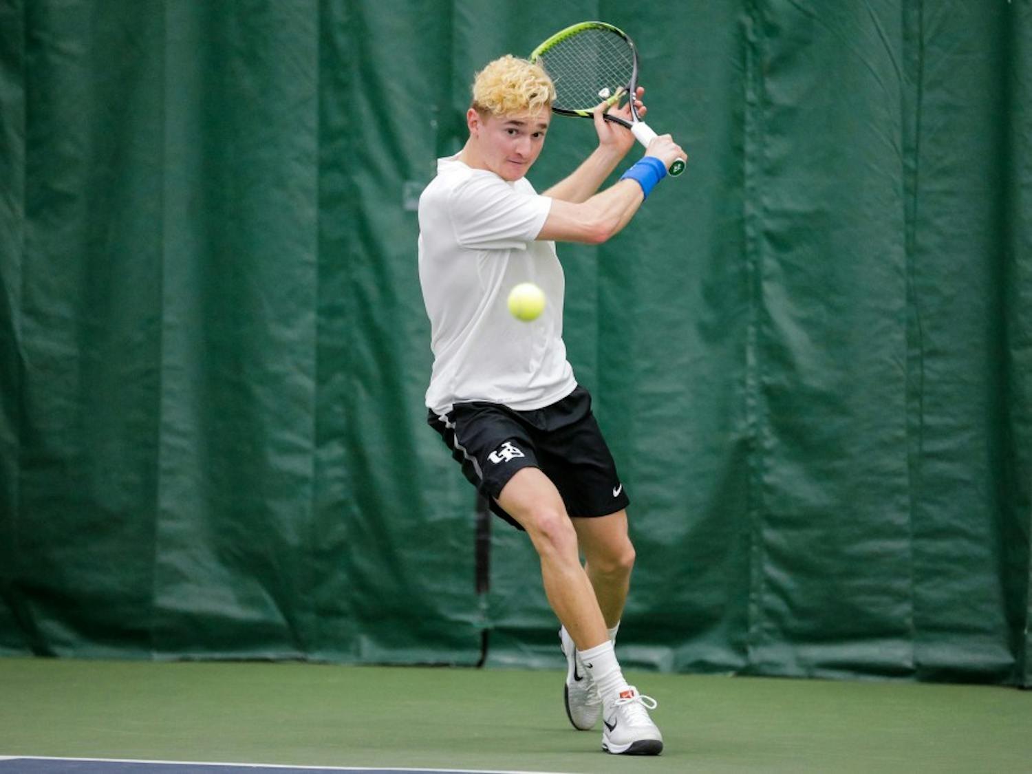 Freshman Nickolas Frisk prepares to hit the ball with a back hand. The Bulls picked up two wins this weekend to improve its conference record to 3-1.