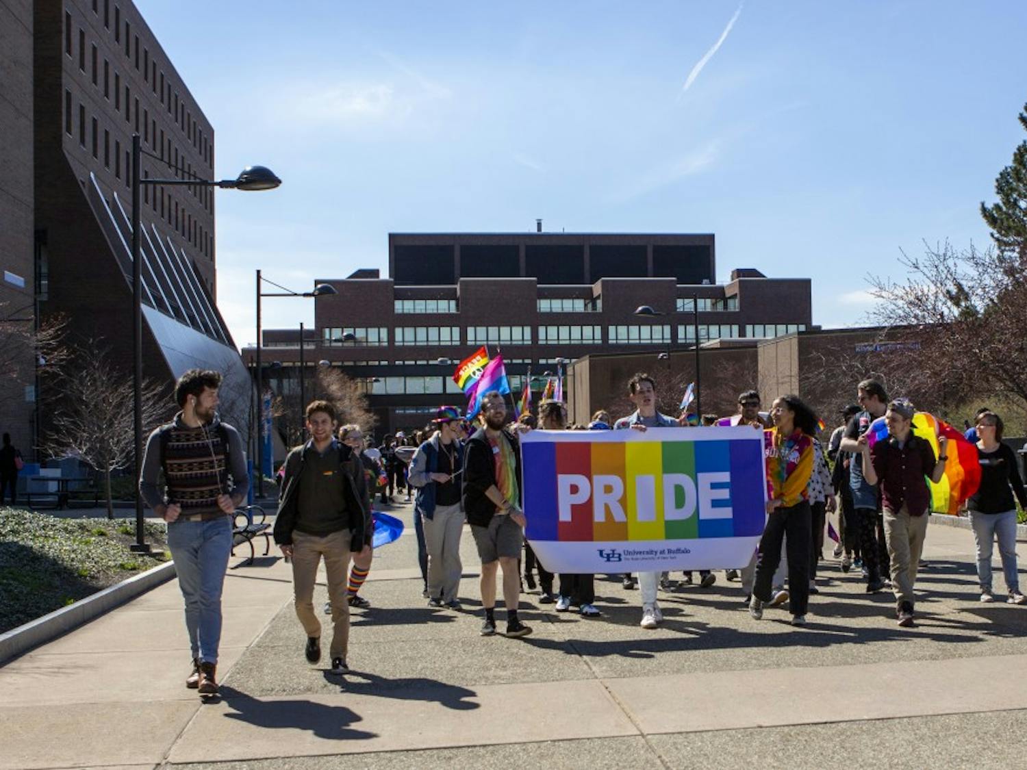 UB students march on the Academic Spine of North Campus for UB’s LGBTQ Pride Parade on Wednesday. Students ended the march at the SU, where they continued with a pride festival.