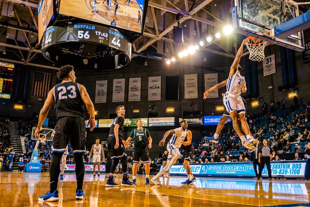 <p>Senior guard Antwain Johnson leaps to dunk at the men’s basketball exhibition game against Daemen College Oct. 24.</p>