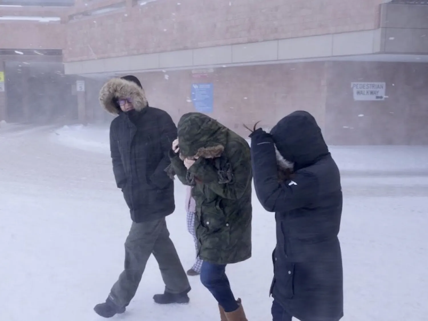 Students walk on North Campus during the snowstorm.