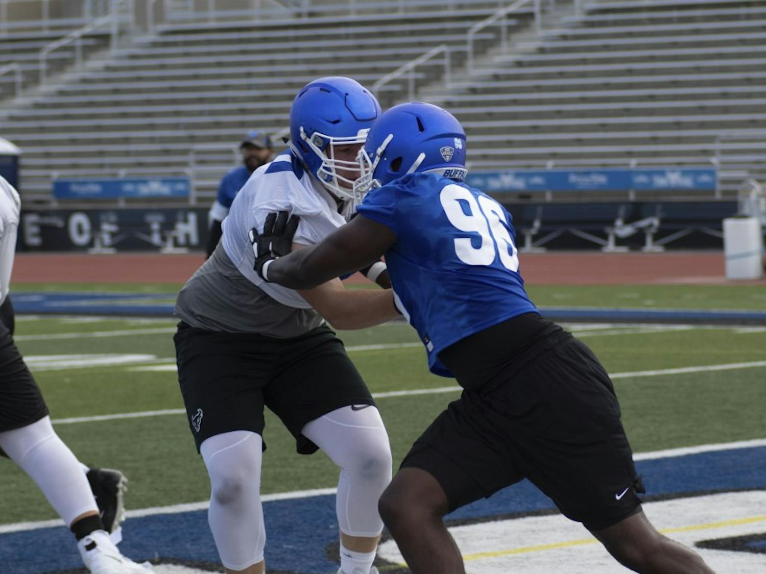 UB defensive end Jordan Avissey holds back offensive lineman during an early season practice.