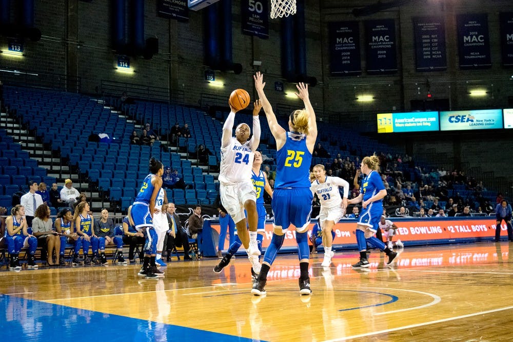 <p>Junior guard Cierra Dillard attempts the layup in coverage. Dillard led the team in scoring in the Bulls' win over Kent State Wednesday night.</p>