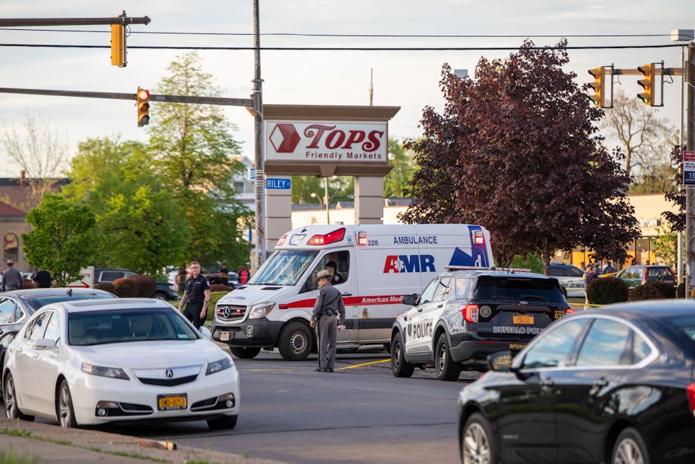 <p>An ambulance stops in front of the parking lot of Tops Friendly Markets at 1275 Jefferson Ave. Saturday afternoon.</p>