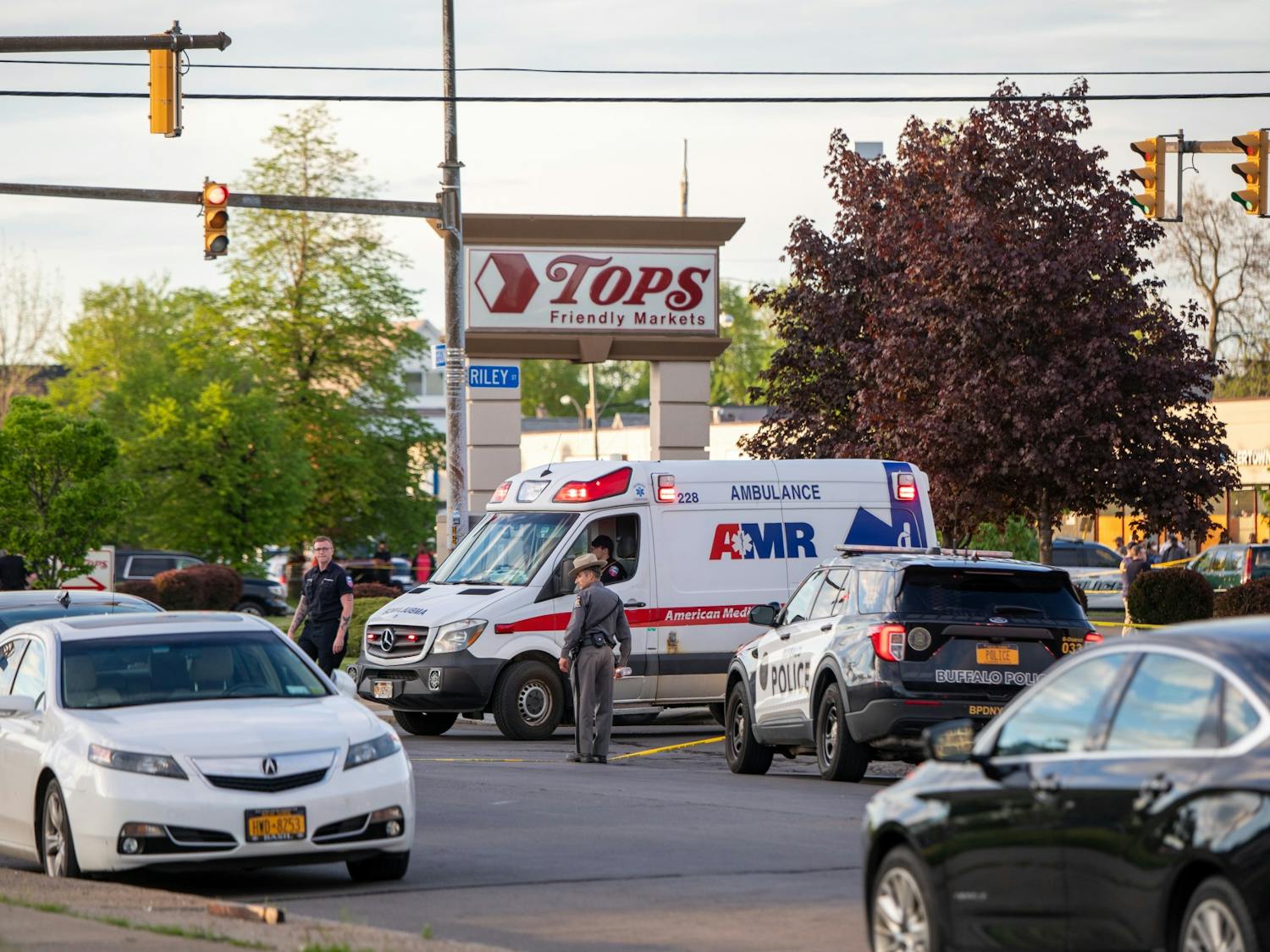 An ambulance stops in front of the parking lot of Tops Friendly Markets at 1275 Jefferson Ave. Saturday afternoon.