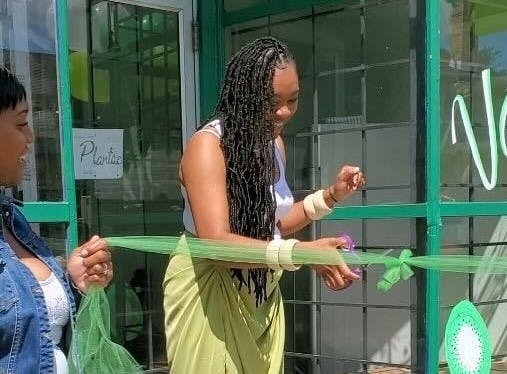 Donisha Gant, owner of Plantae, cuts the ribbon at her store’s grand opening ceremony. &nbsp;