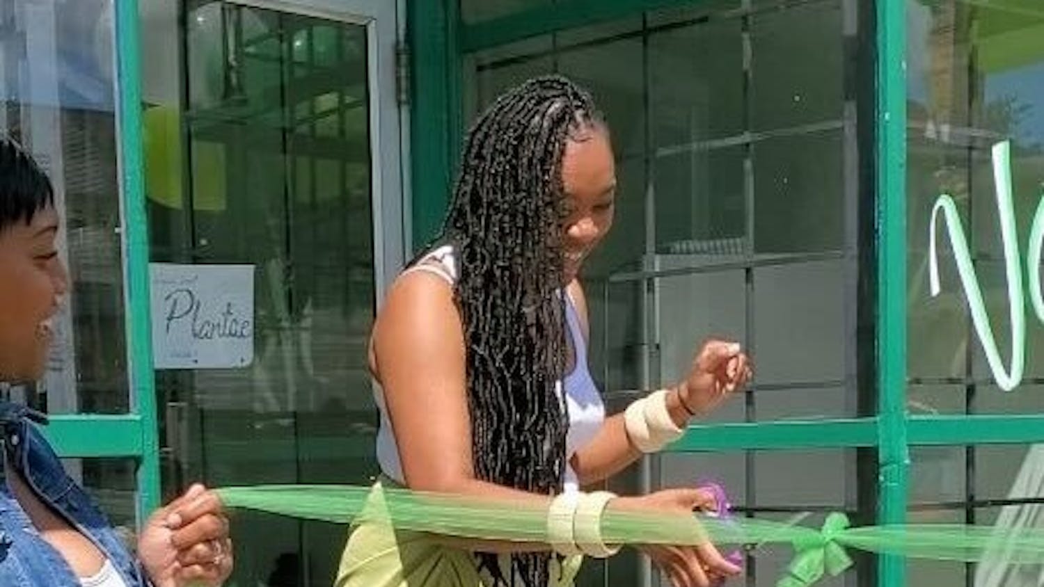 Donisha Gant, owner of Plantae, cuts the ribbon at her store’s grand opening ceremony. &nbsp;