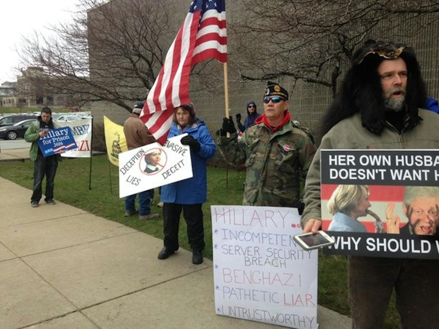 Protesters stand outside the Buffalo Transportation Pierce Arrow Museum where Democratic presidential candidate Hillary Clinton spoke Friday afternoon. Both Clinton supporters and protesters stood outside once the fire marshal had to close the doors due to the building reaching capacity. 