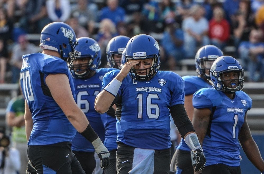 <p>Former Bulls quarterback Joe Licata, with "New York" featured prominently on his jersey,&nbsp;walks off the field during a loss to Nevada at UB Stadium in September of 2015.&nbsp;Licata preferred the jerseys with the "Buffalo" patch that the team wore during his freshman season.&nbsp;</p>