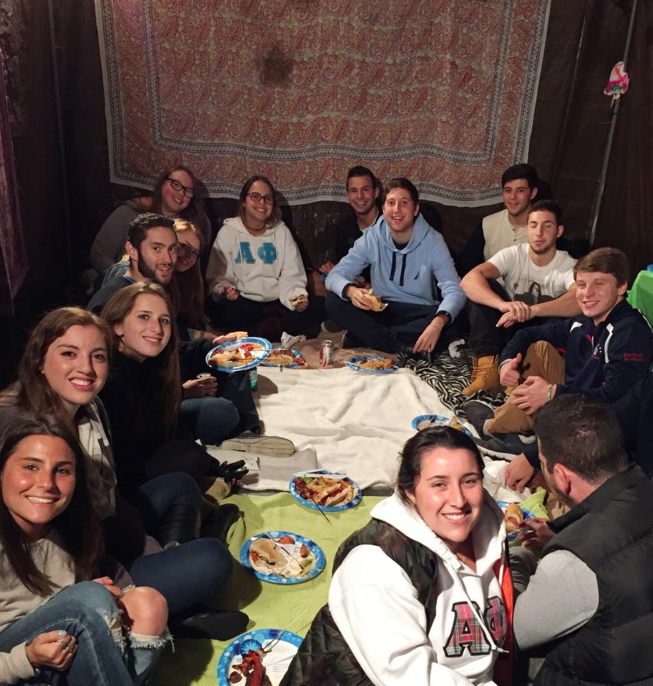 UB students hang out and eat food in the Sukkah for the first meeting of Aish Buffalo, a new Jewish organization on campus.