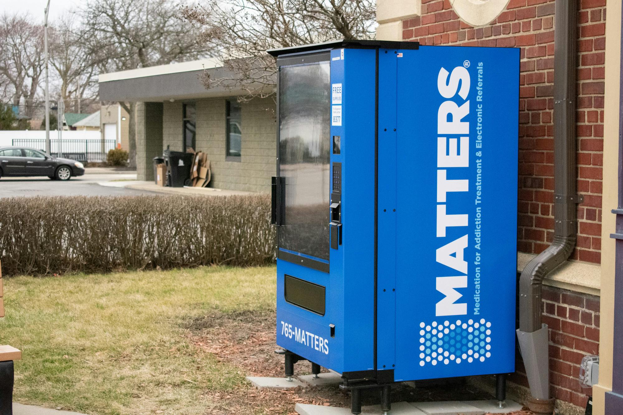 A vending machine established by the MATTERS network provides free Narcan and test strips outside of the Kenmore Fire Department. 