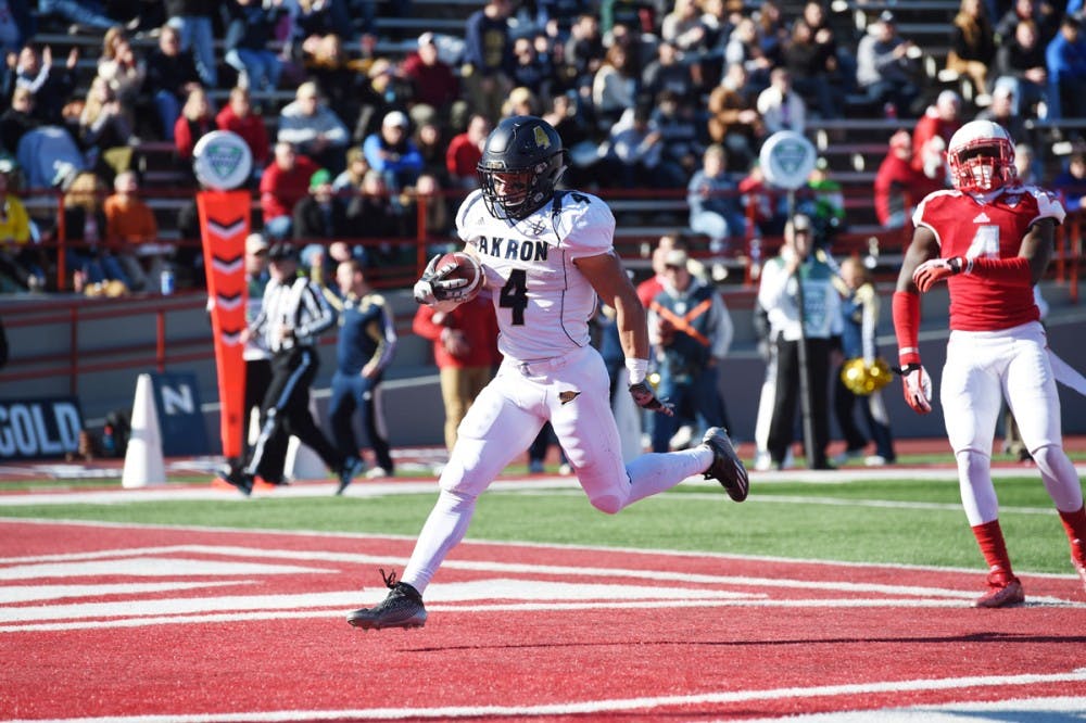 <p>Akron running back Conor Hundley runs into the end zone on a scoring drive. Akron and Buffalo are both one win away from Bowl eligibility.</p>