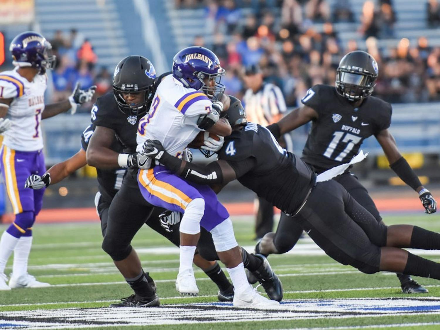 Sophomore linebacker Khalil Hodge tackles UAlbany player.&nbsp;Hodge, a&nbsp;JUCO transfer from California, already appears to be in full command as a leader on UB's&nbsp;defense.