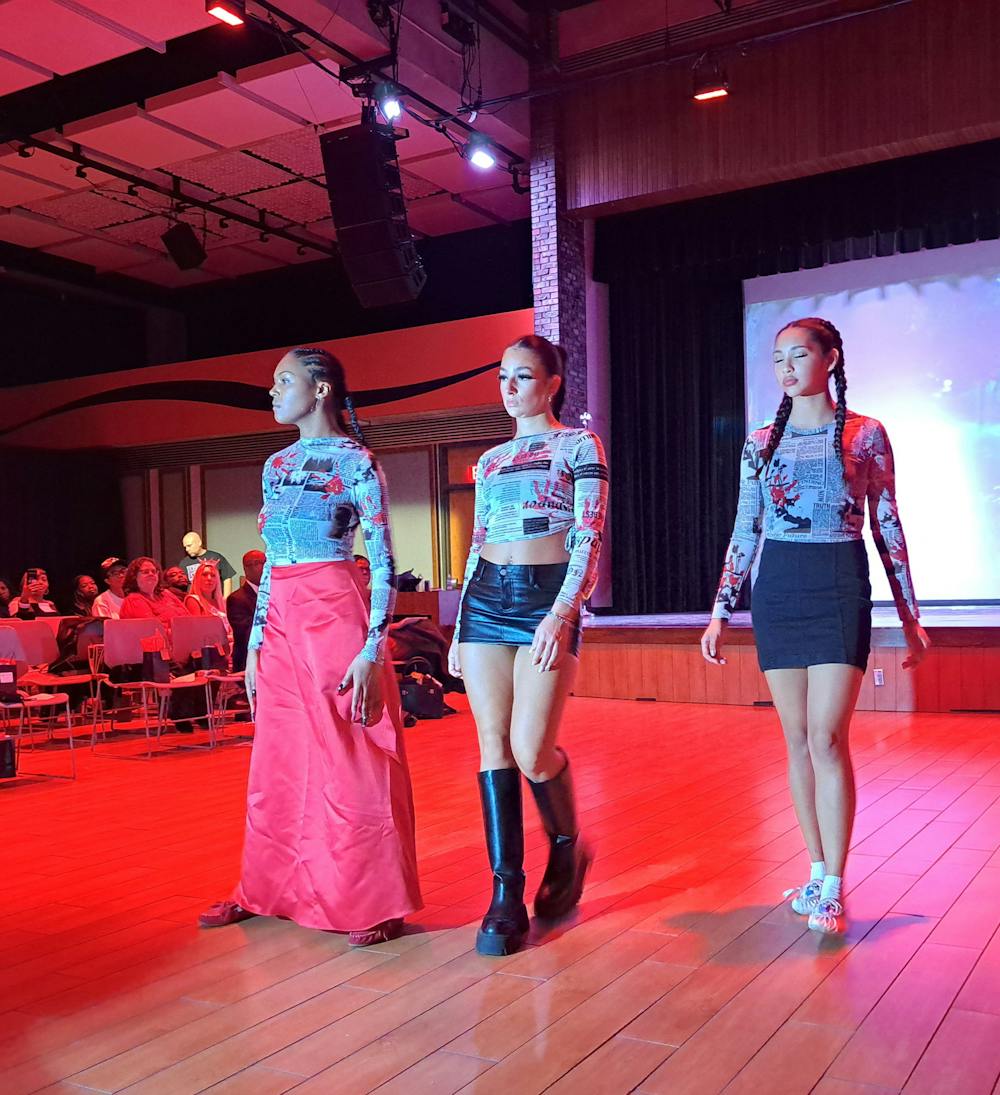 Three models walking down the runway of Aiyana Jacy Martin’s "Walk in Her Shoes."