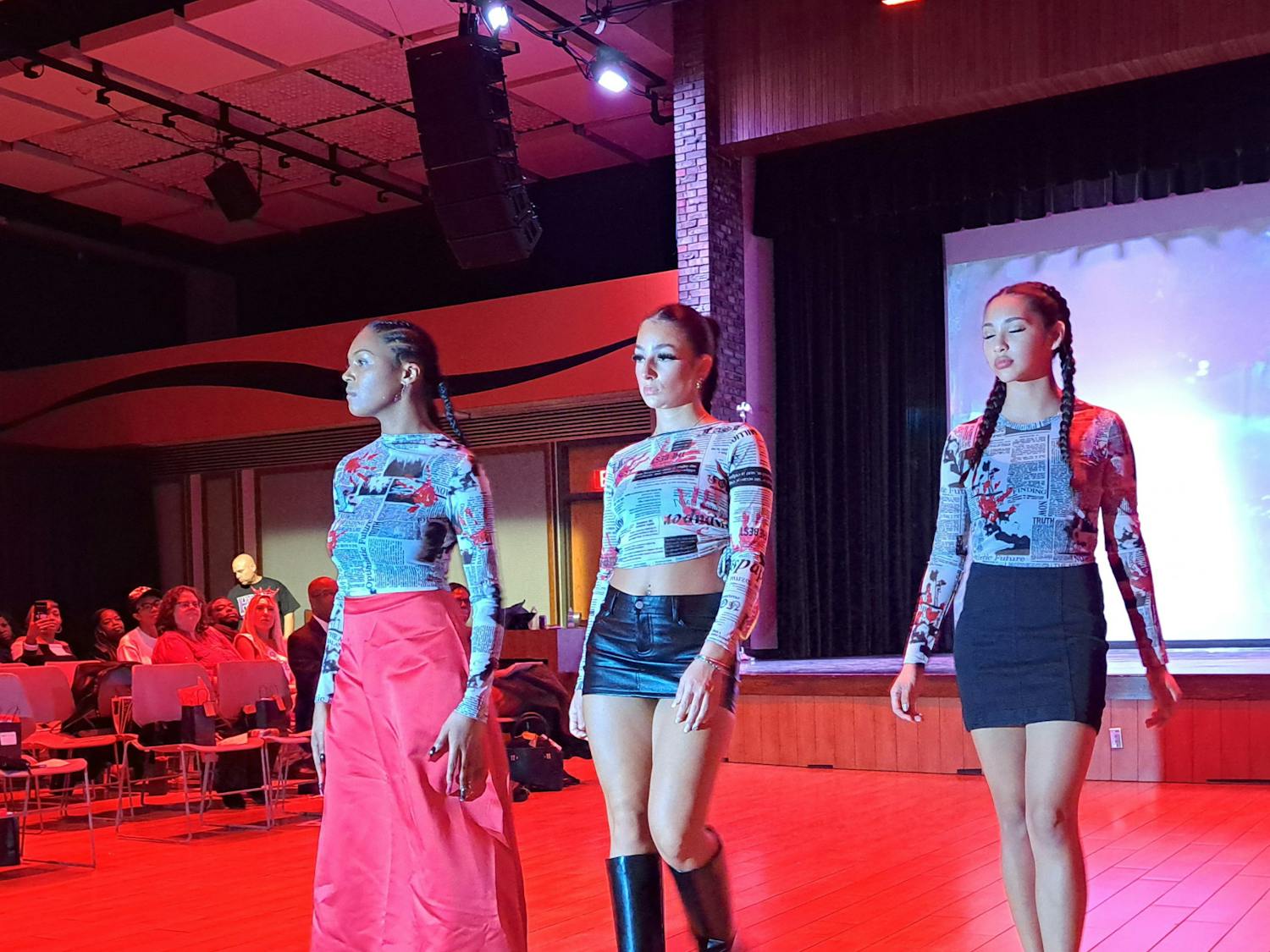 Three models walking down the runway of Aiyana Jacy Martin’s "Walk in Her Shoes."