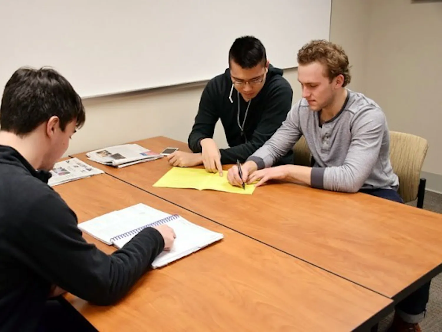 Senior accounting majors (left to right) Andrew Robertson, Andrew Leung and Spencer Gates look over paperwork. The three are part of UB’s VITA program, which provides free tax services to the local community. Angela Barca, The Spectrum