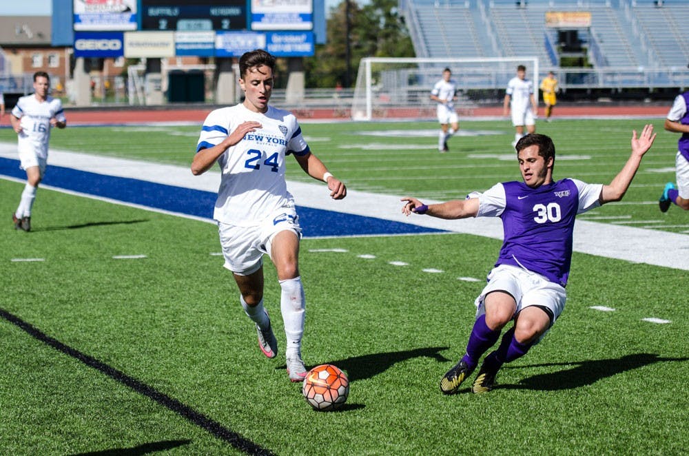 <p>Senior midfielder Brandon Scales dribbles past a Niagara defender last season. The Bulls will play Niagara University Thursday night seeking their seventh consecutive victory to open the season.</p>