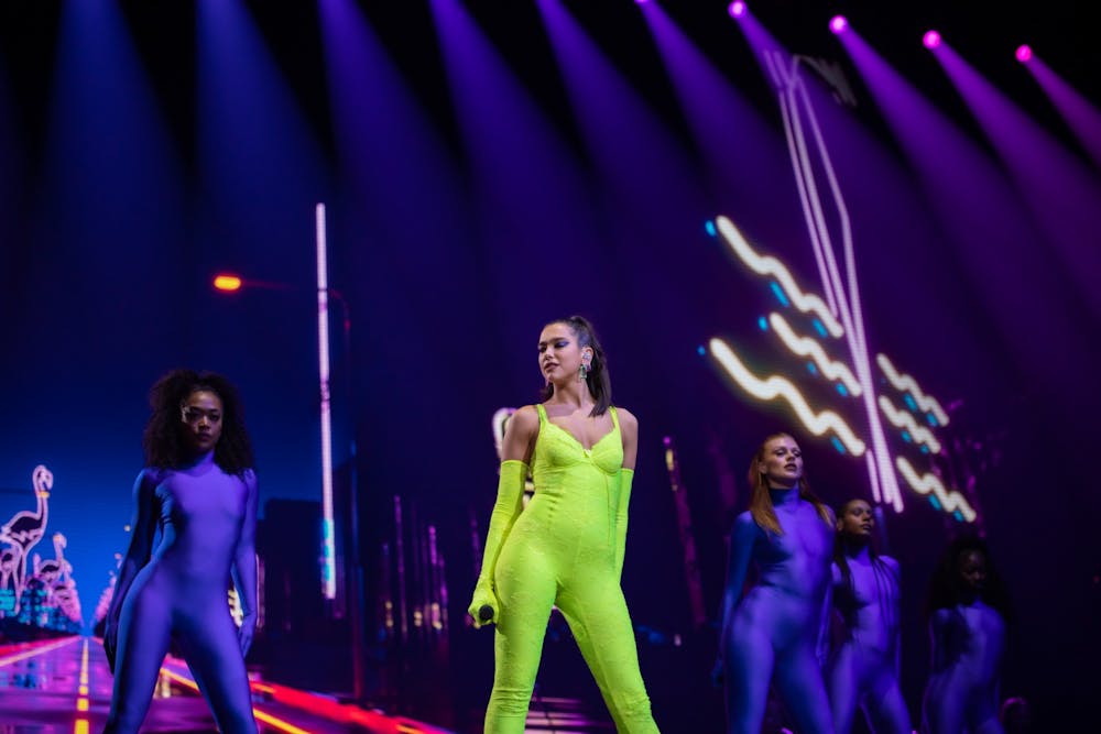 <p>Dua Lipa poses while performing in front of backup singers Saturday at KeyBank Center.&nbsp;</p>