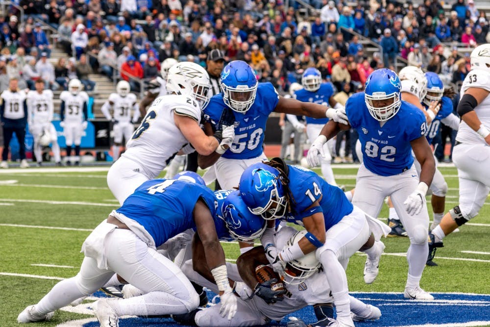 <p>The Bulls defense swarms an Akron player at UB Stadium. The Bulls will return home this week to take on the Miami (OH) RedHawks.</p>