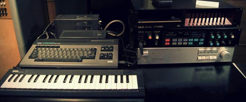 A photo of a Yamaha CX5M music computer set, including a keyboard, computer and sound synthesizer, along with an Akai S612 set of a sampler disk drive and MIDI digital sampler.