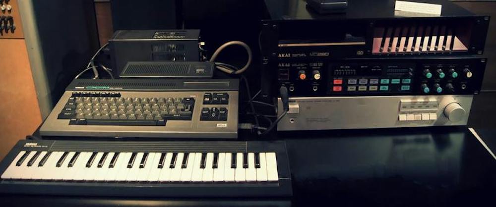 A photo of a Yamaha CX5M music computer set, including a keyboard, computer and sound synthesizer, along with an Akai S612 set of a sampler disk drive and MIDI digital sampler.