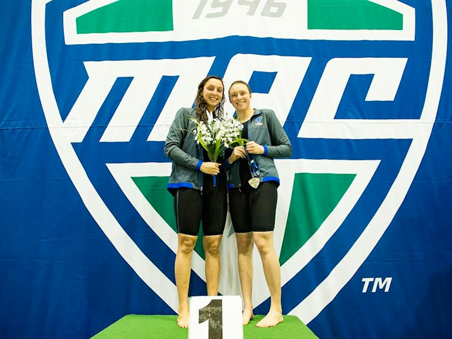 Megan Burns celebrates winning the 50-yard freestyle with teammate Eve Kosten.