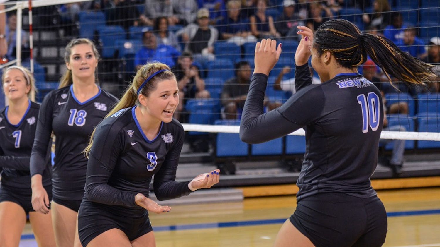 Senior Marissa Prinzbach (left)&nbsp;and senior Akelia Lain (right) celebrate a point from earlier in the season. The Bulls clinched the No. 7 seed in the MAC Tournament, their second berth in as many years.