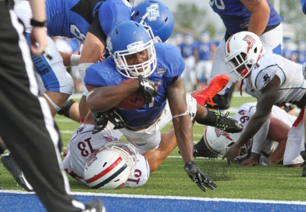 Junior running back Anthone Taylor scores his second of two touchdowns in Buffalo&#39;s 38-28 victory over Duquesne. Taylor finished with 115 rushing yards on 30 carries.