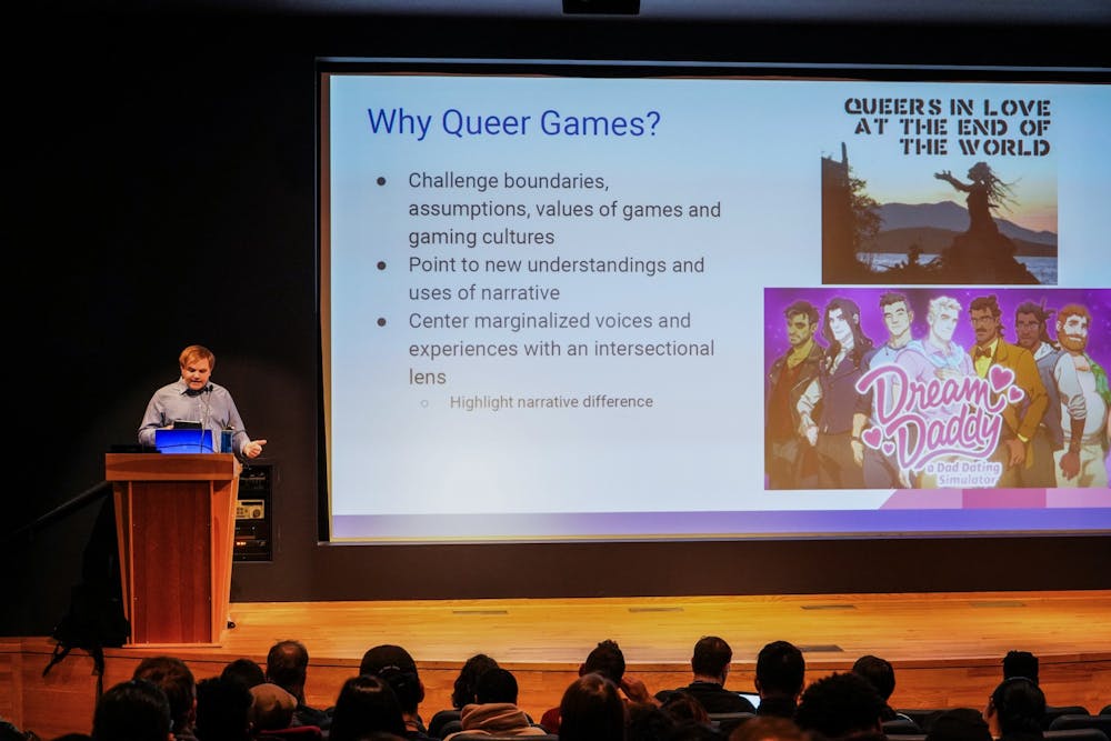 <p>Assistant professor Cody Mejeur, Ph.D. lectures students on narrative video games involving the topics of gender and queer narrative to UB students Monday night at the Center for the Arts.</p>