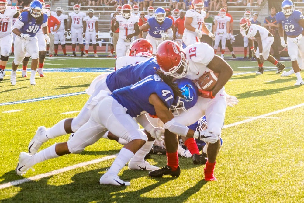 Senior free safety Brandon Williams tackles a Delaware State player. Williams typically wears number 14 but wore number 41 in Saturday’s game to honor teammate Solomon Jackson.