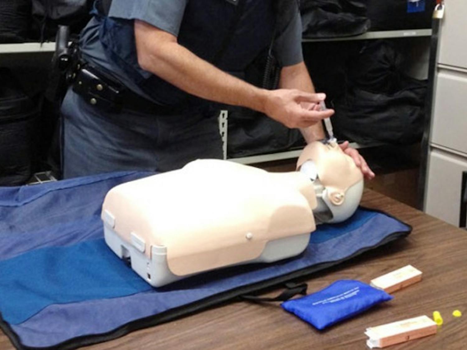 University Police Lt. David Urbanek demonstrates
the nasal administrationof a heroin antidote. Antidote kits have
been recently supplied to 12 SUNY campuses as heroin-related deaths
increase across New York State.
Athita Unni, The Spectrum