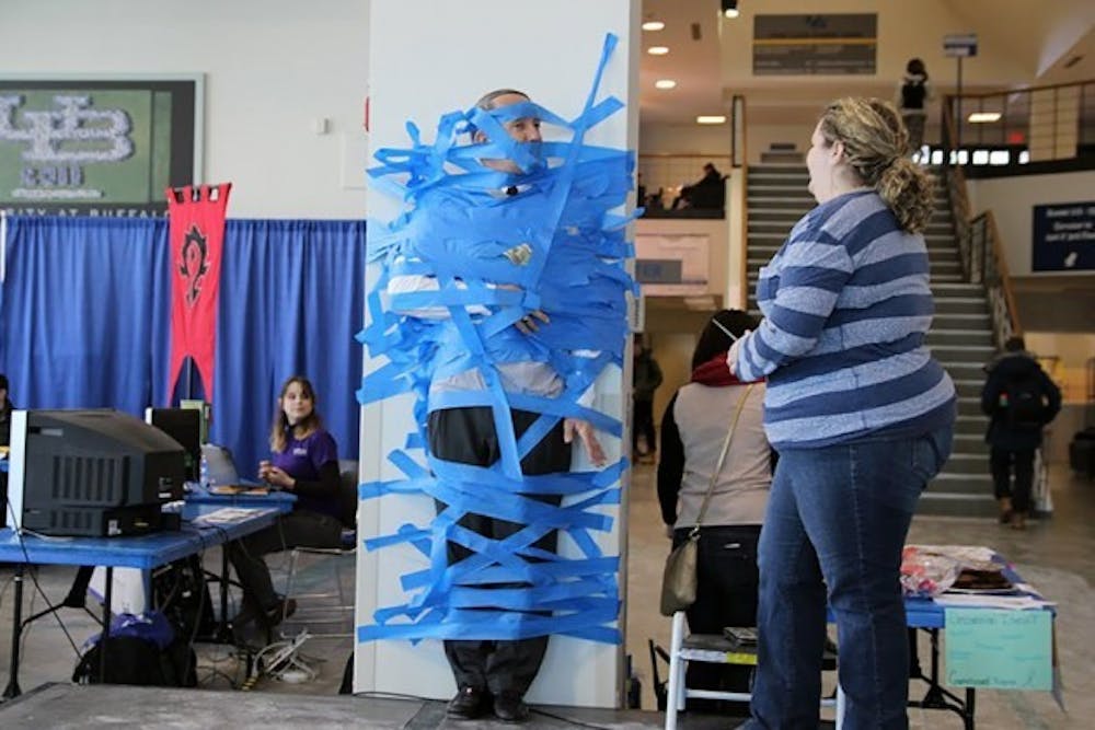 Students paid $1 to tape Dennis Black, vice president for University Life and Services, to a wall in the Student Union to raise money for Relay for Life.&nbsp;&nbsp;Emily Li, The Spectrum