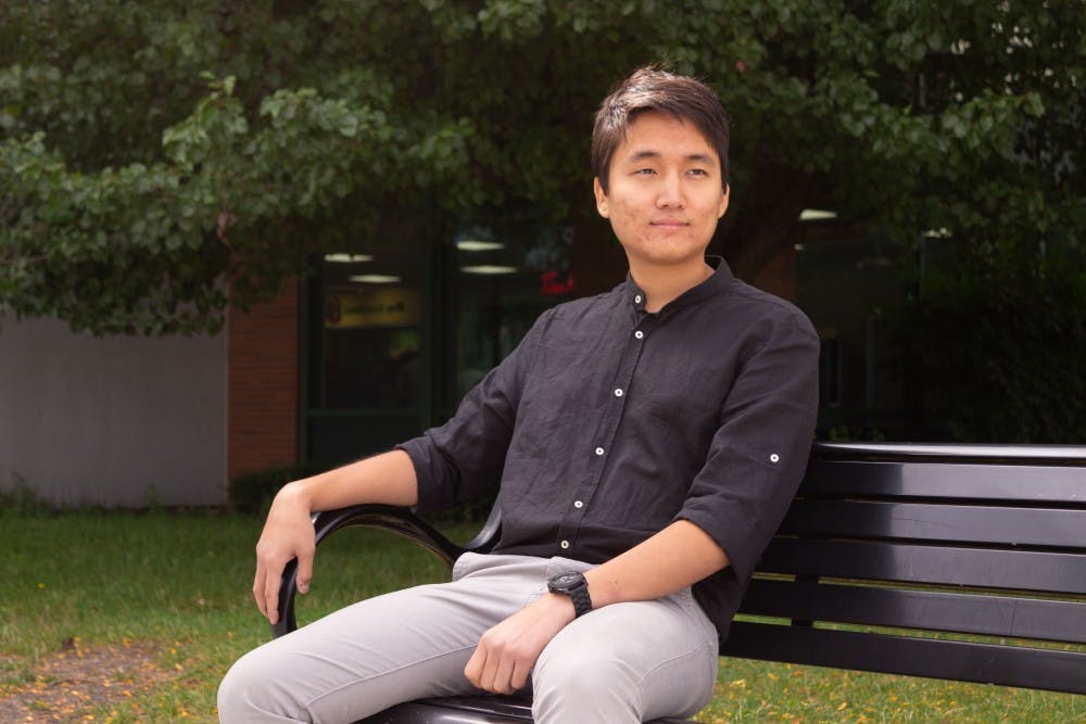 <p>Portrait of Daeil Kim sitting outside the student union.</p>