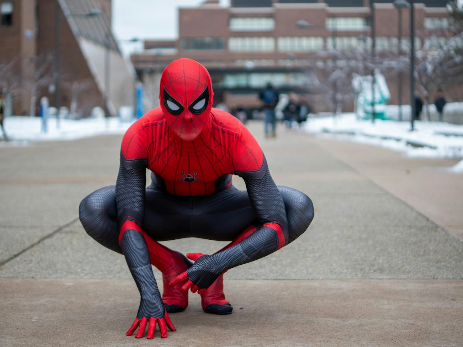 UB Spider-Man recreates iconic Spider-Man poses outside Student Union.