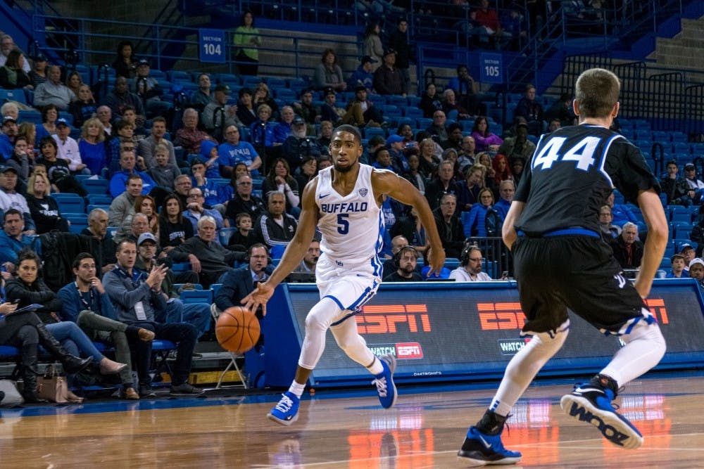 <p>Senior guard CJ Massinburg dribbles at the three-point line. Massinburg led the Bulls with 21 points and four rebounds, including going 11-12 from the free-throw line.</p>