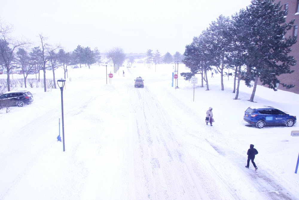 <p>UB students walk through over a foot&nbsp;of snow on North Campus Wednesday morning. Students were upset UB did not cancel classes Wednesday.&nbsp;</p>