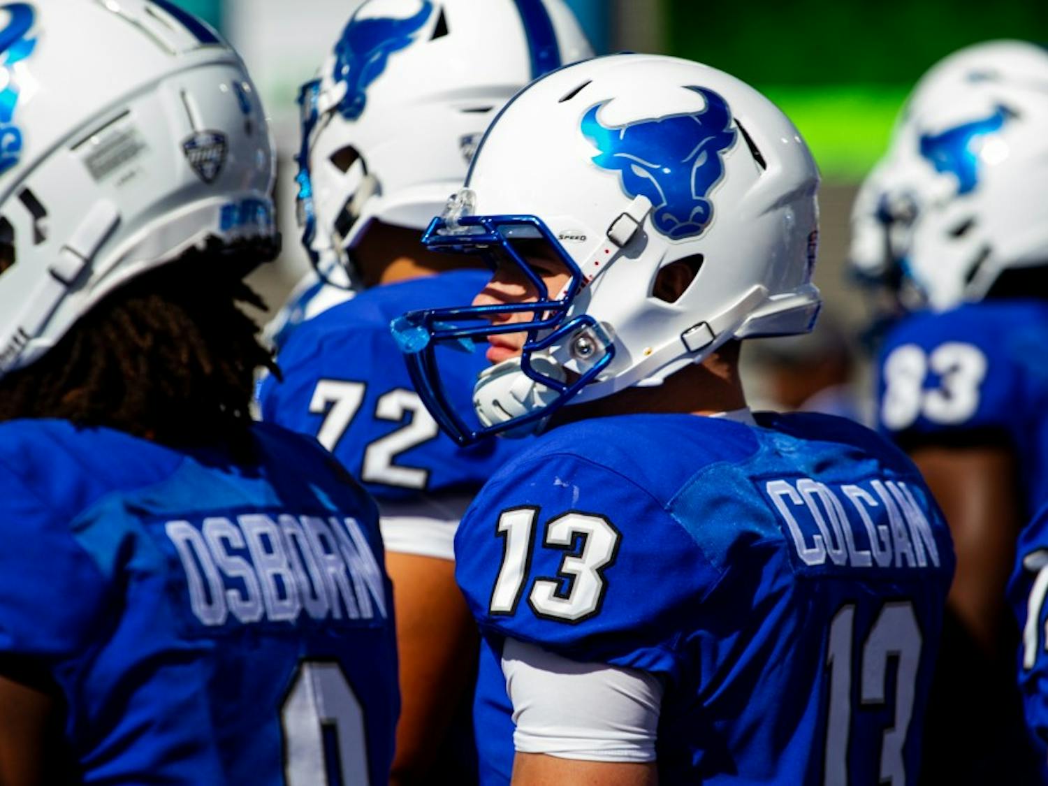 UB players stand together along the sideline. The Bulls are hoping for a large crowd this weekend for UB’s homecoming and does not want to disappoint like they did against Army.