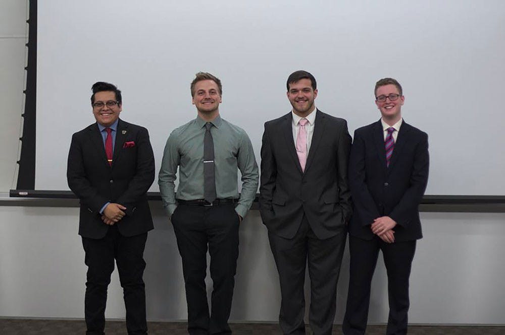 <p>from left to right: Carlos Leyte, a senior business student, Matthew McKinivan, a senior economics major, James Gomez, a senior economics major and Kyle Murphy, a sophomore accounting major prepare for their first debate about immigration.</p>