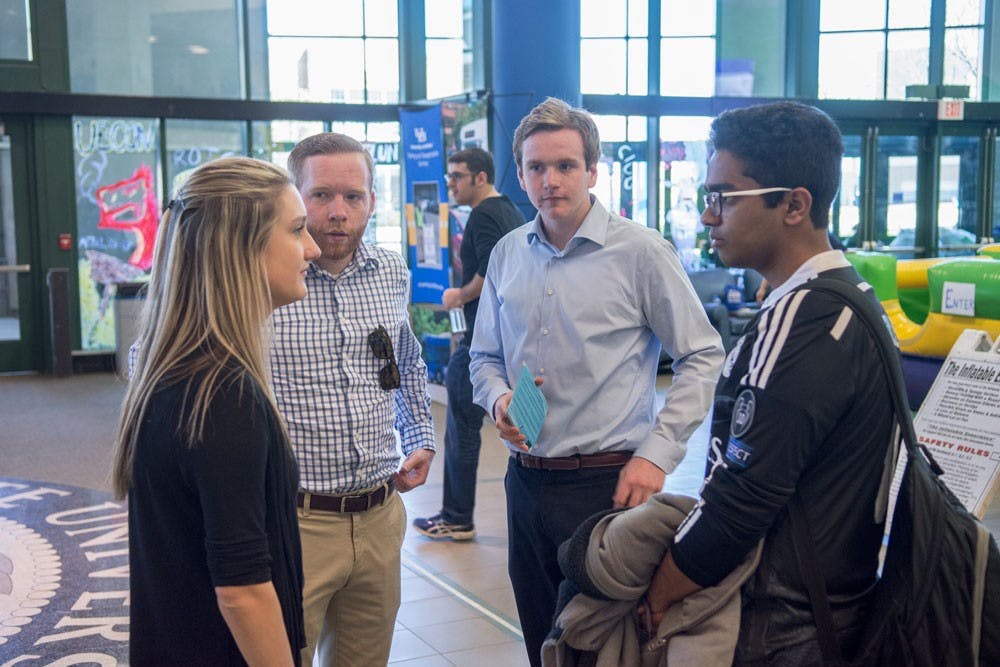 <p>Progress Party's Megan Glander (far left) and Dan Emmons (second from right) campaign in the Student Union&nbsp;Tuesday. <em>The Spectrum</em>'s exit polls show Progress has an early lead after the first day of voting for the Student Association elections.&nbsp;</p>