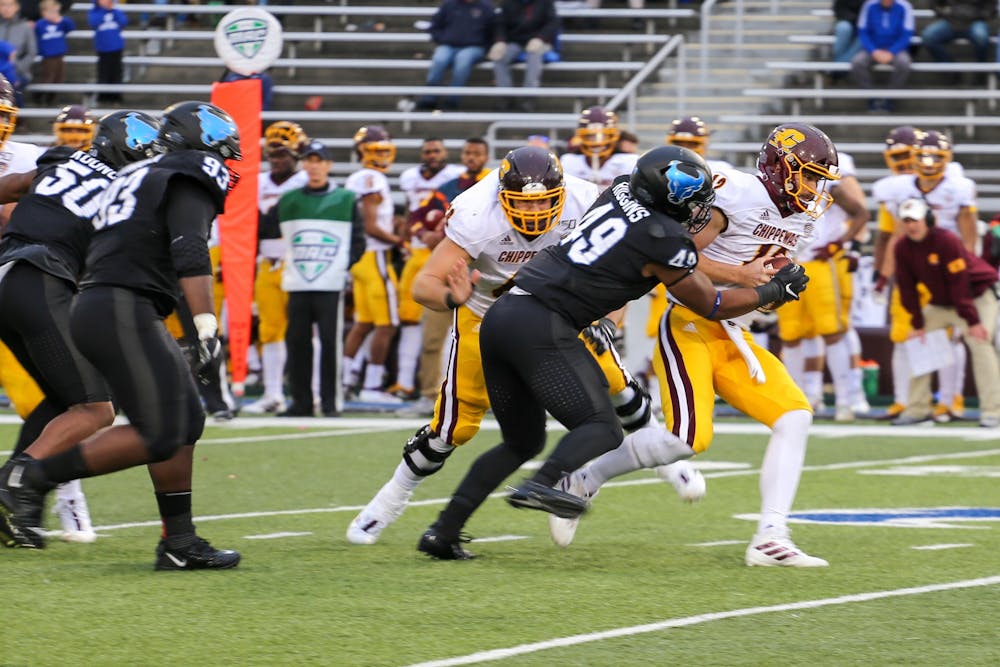 <p>Defensive end Taylor Riggins sacking quarterback Quinten Dormady.</p>