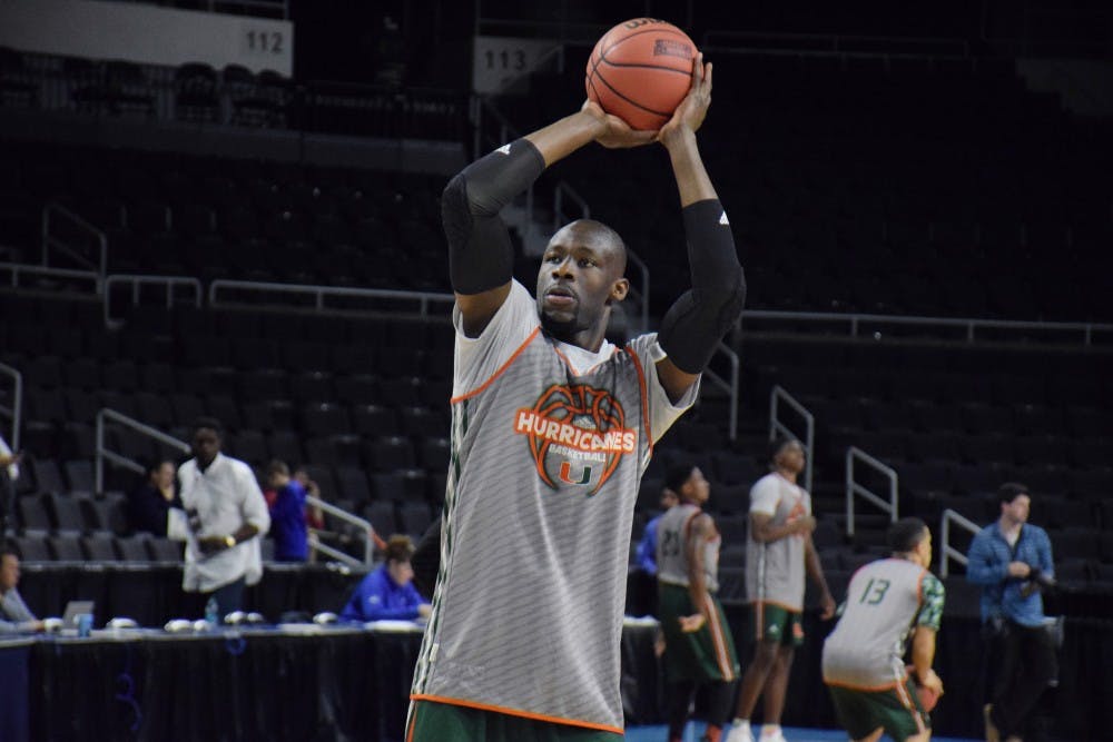Miami senior center Tonye Jekiri takes a shot during the Hurricanes' open practice at the Dunkin' Donuts Center Wednesday.&nbsp;