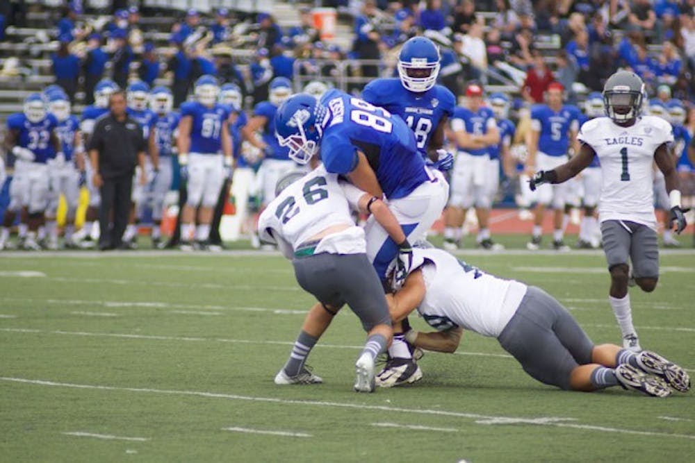 <p>Junior tight end Matt Weiser is tackled by two Eastern Michigan defenders in the Bulls’ 42-14 victory on the Eagles at UB Stadium on Oct. 5 2013.&nbsp;</p>