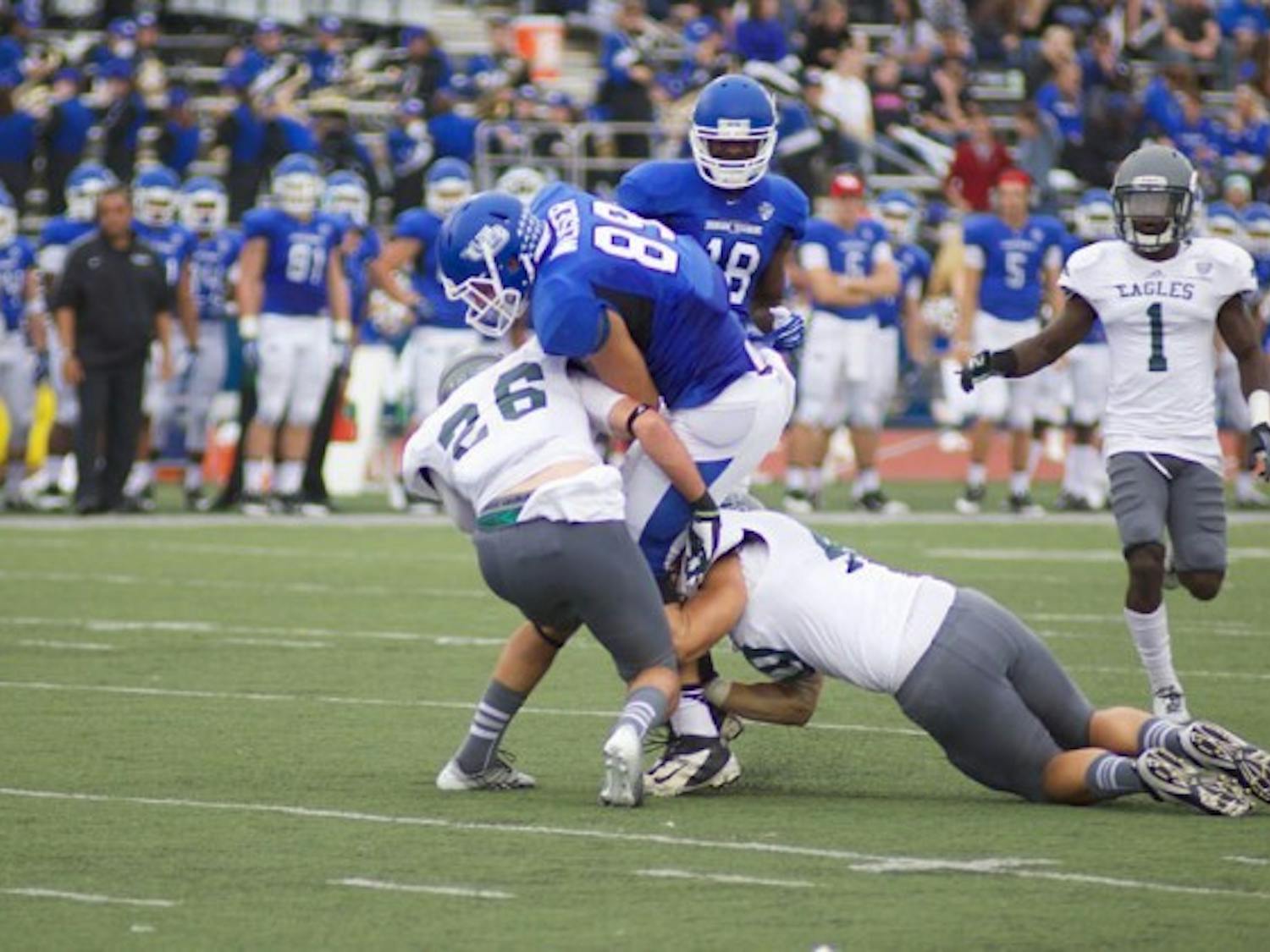 Junior tight end Matt Weiser is tackled by two Eastern Michigan defenders in the Bulls’ 42-14 victory on the Eagles at UB Stadium on Oct. 5 2013.&nbsp;