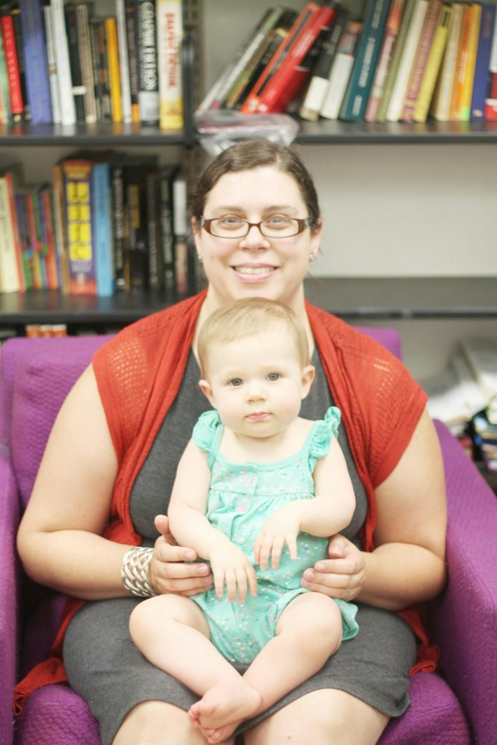 <p>Leslie Nickerson sits with her one-year-old daughter. Nickerson, a TA and English Ph.D candidate at UB, has had to balance her work and motherhood while being financially unstable.</p>