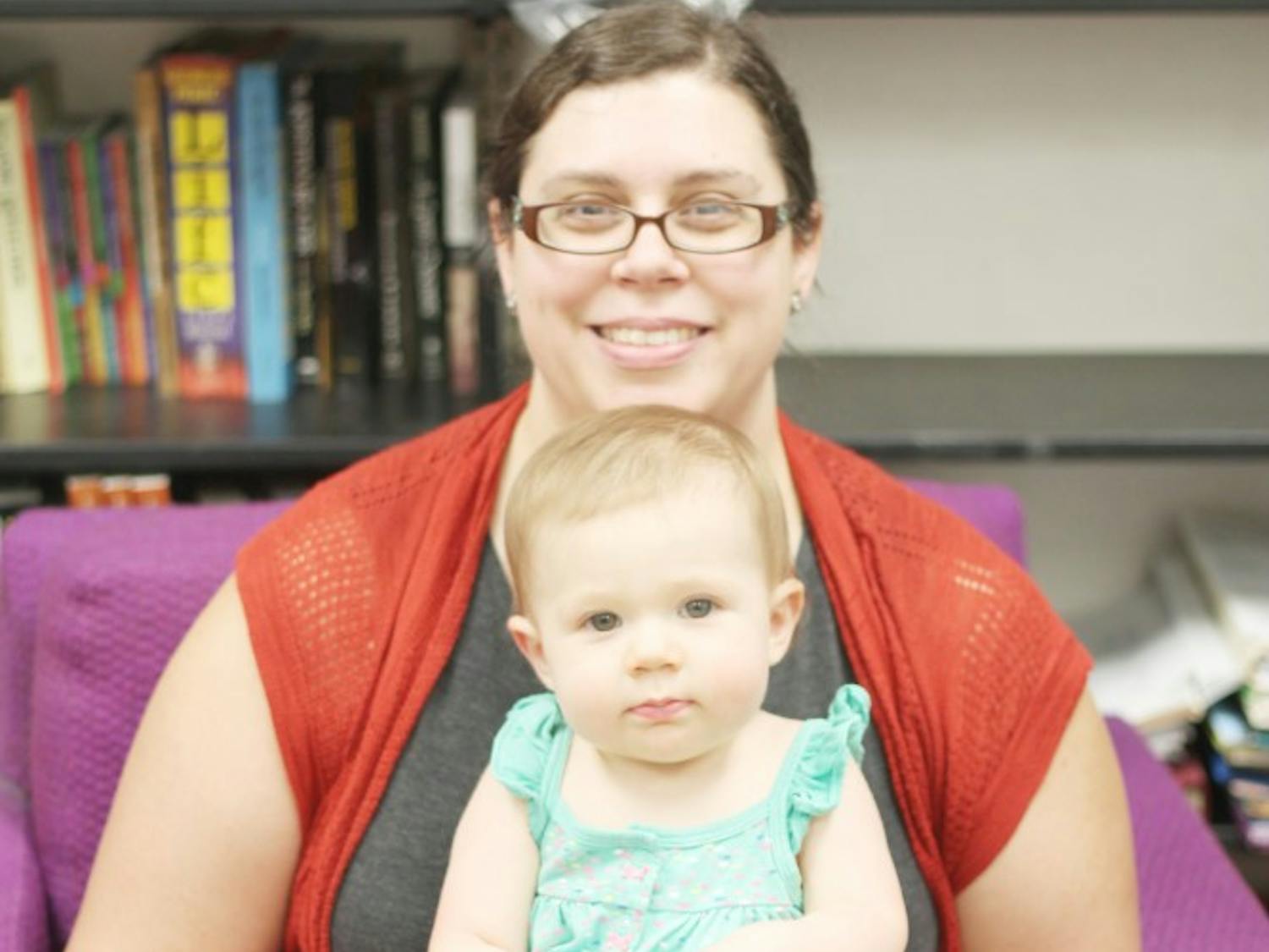 Leslie Nickerson sits with her one-year-old daughter. Nickerson, a TA and English Ph.D candidate at UB, has had to balance her work and motherhood while being financially unstable.