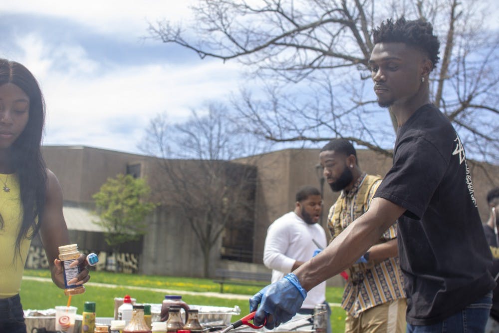 <p>Daniel Edwards, BSU vice president, helps prepare food at the club’s annual BBQ on Sunday.</p>