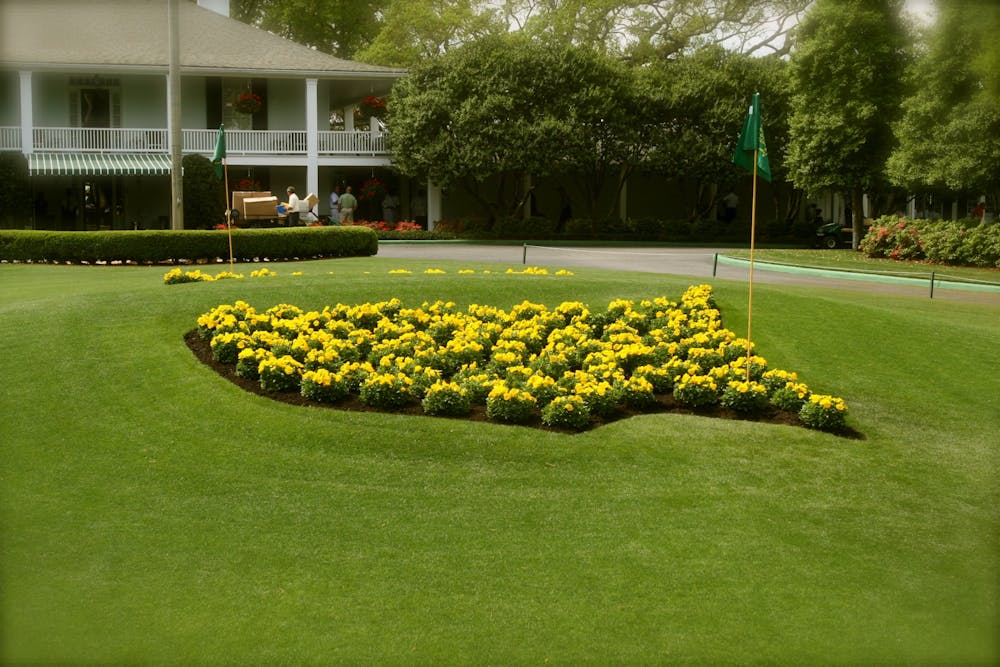 The logo for the Masters Tournament made of flowers, in front of the clubhouse of the Augusta National Golf Club.